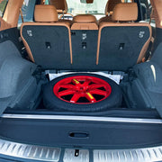 Spare tire fitted inside the wheel well of the 2025 Genesis GV80, perfectly matching the storage space.