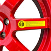 A yellow maximum speed warning label is attached to a close-up image of an EZ spare wheel rim indicating a speed limit.