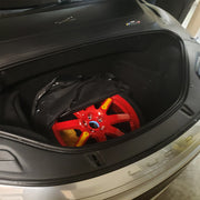 Spare Wheel/Tire Stored in Lucid Front Trunk: A compact spare wheel and tire securely placed inside the front trunk of a Lucid vehicle for emergency use.